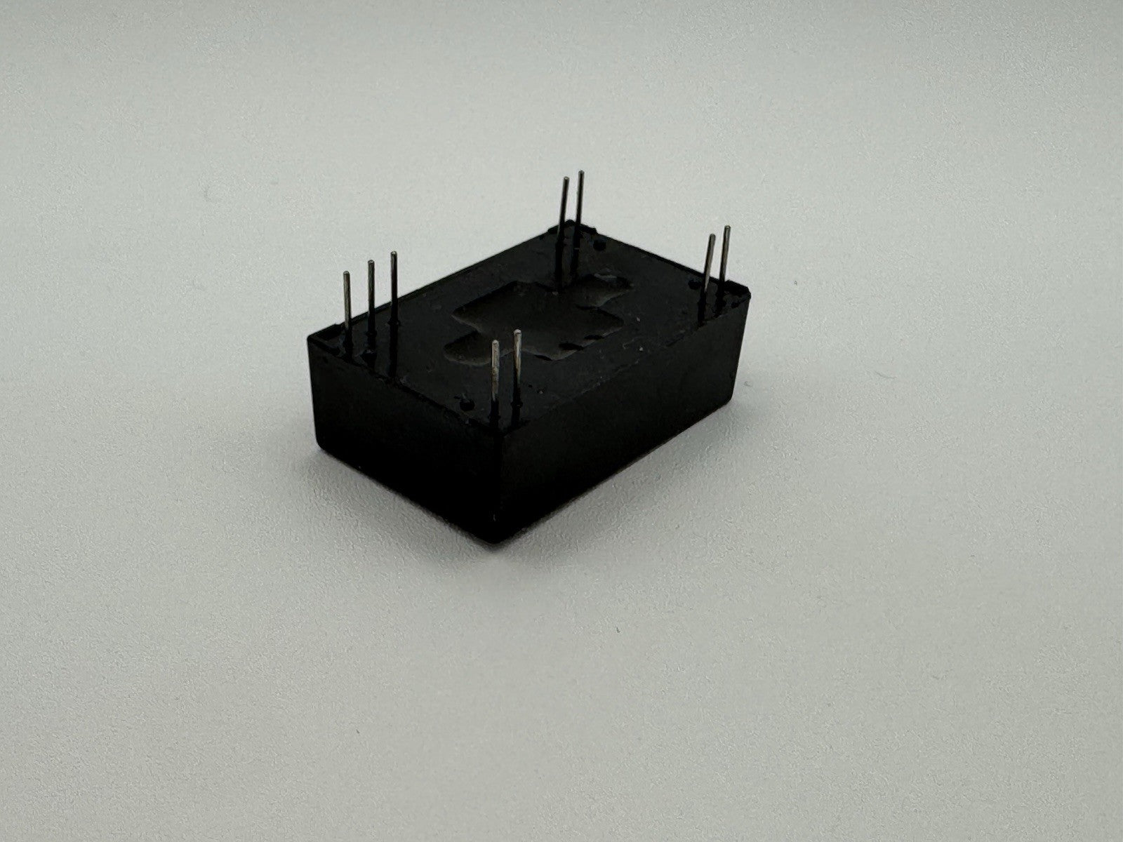 Burr-Brown PWR1310A Isolated DC/DC Converter | ±12V Dual Output 2W Module in black housing with pins.