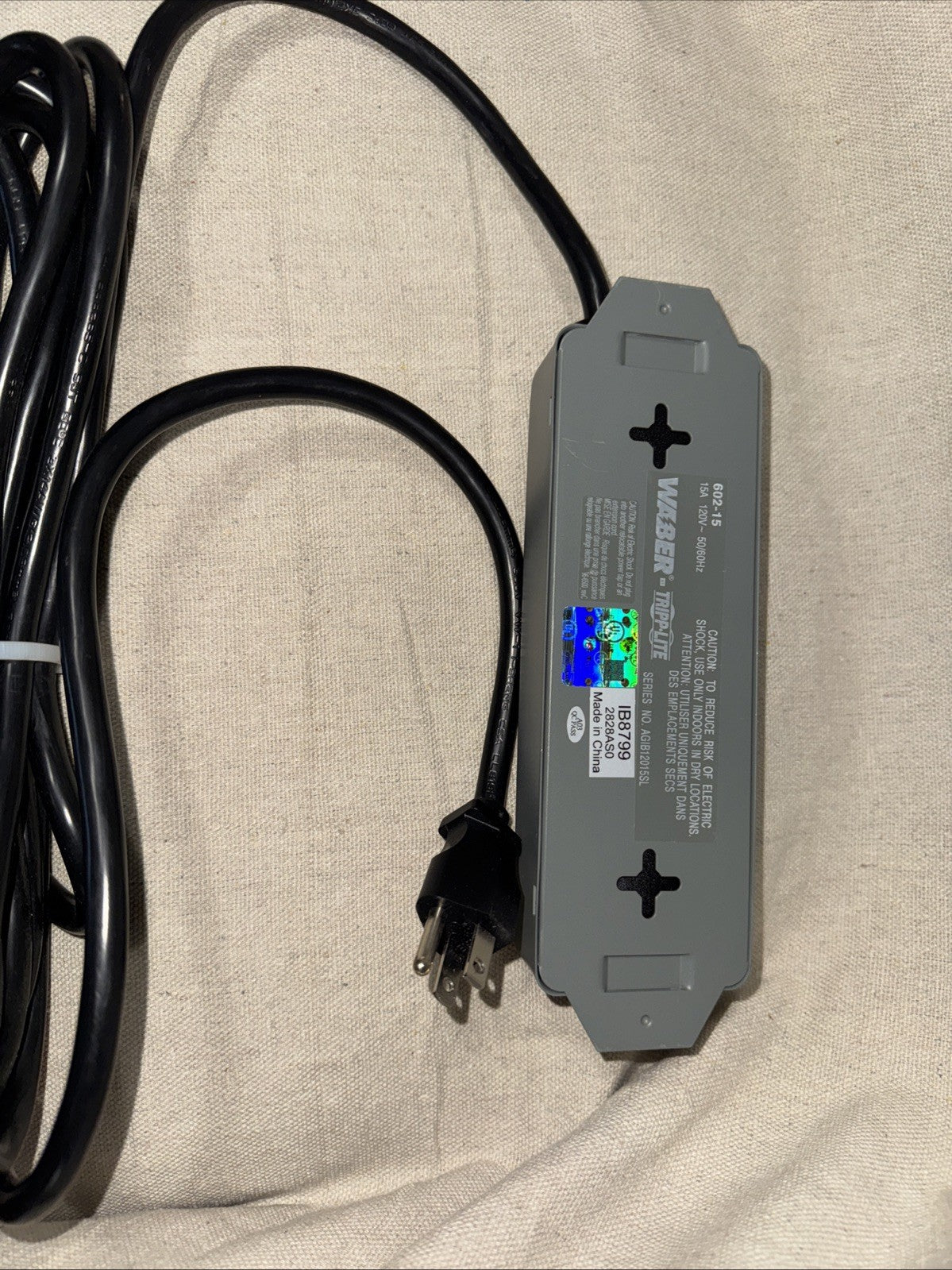 Eaton Corp 602-15 Tripp Lite Waber Power Strip 5-Outlet Industrial 5-15R 5-15P on a fabric surface