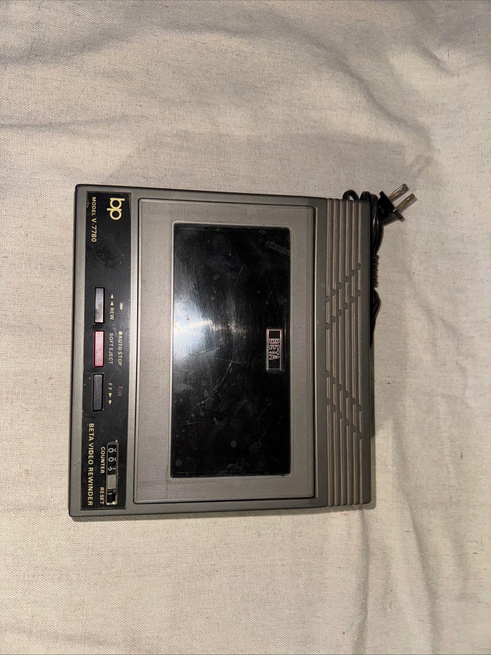 BP Beta VHS Rewinder Fast-forward Dual Machine V-7780 on a light background, showing buttons and controls.