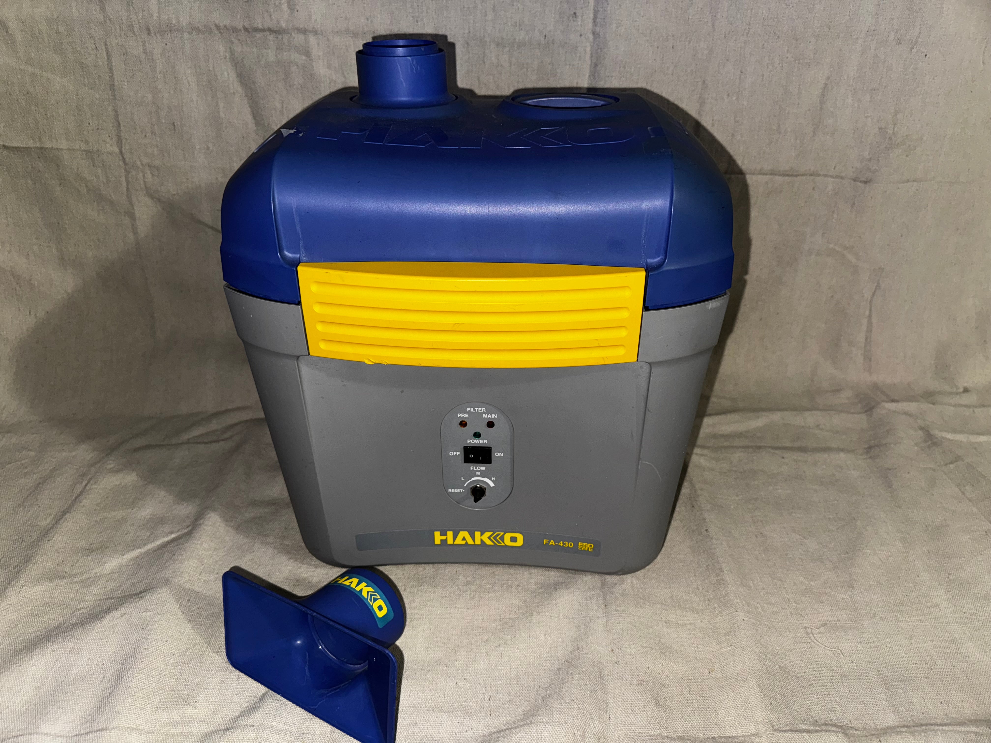 Hakko FA-430 Soldering Fume Extractor with blue and gray design, showing top view and removable nozzle.