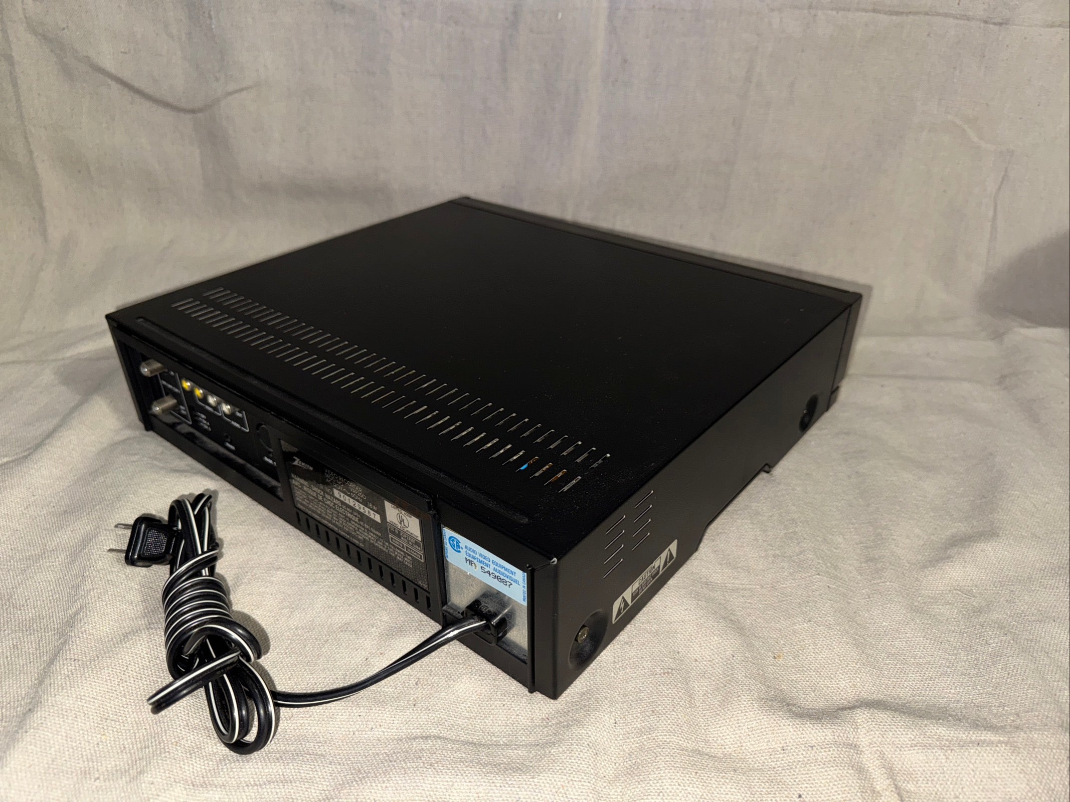 Serviced Zenith VRF250: black electronic device with connections and power cord, serviced and in great working condition.