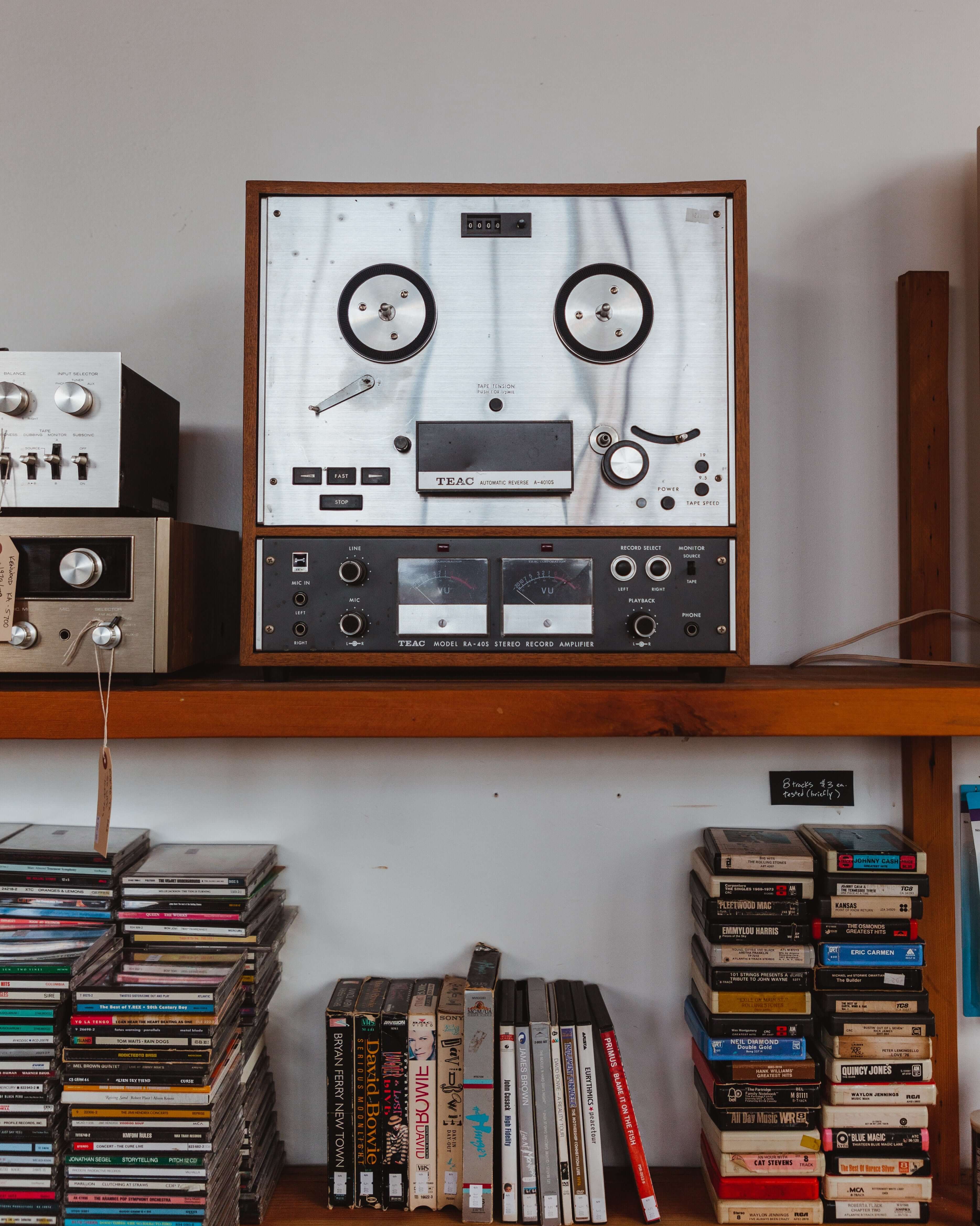 Audio Reel to Reel Tape Player Mail In Repair Service Estimate on display with CDs and tapes.