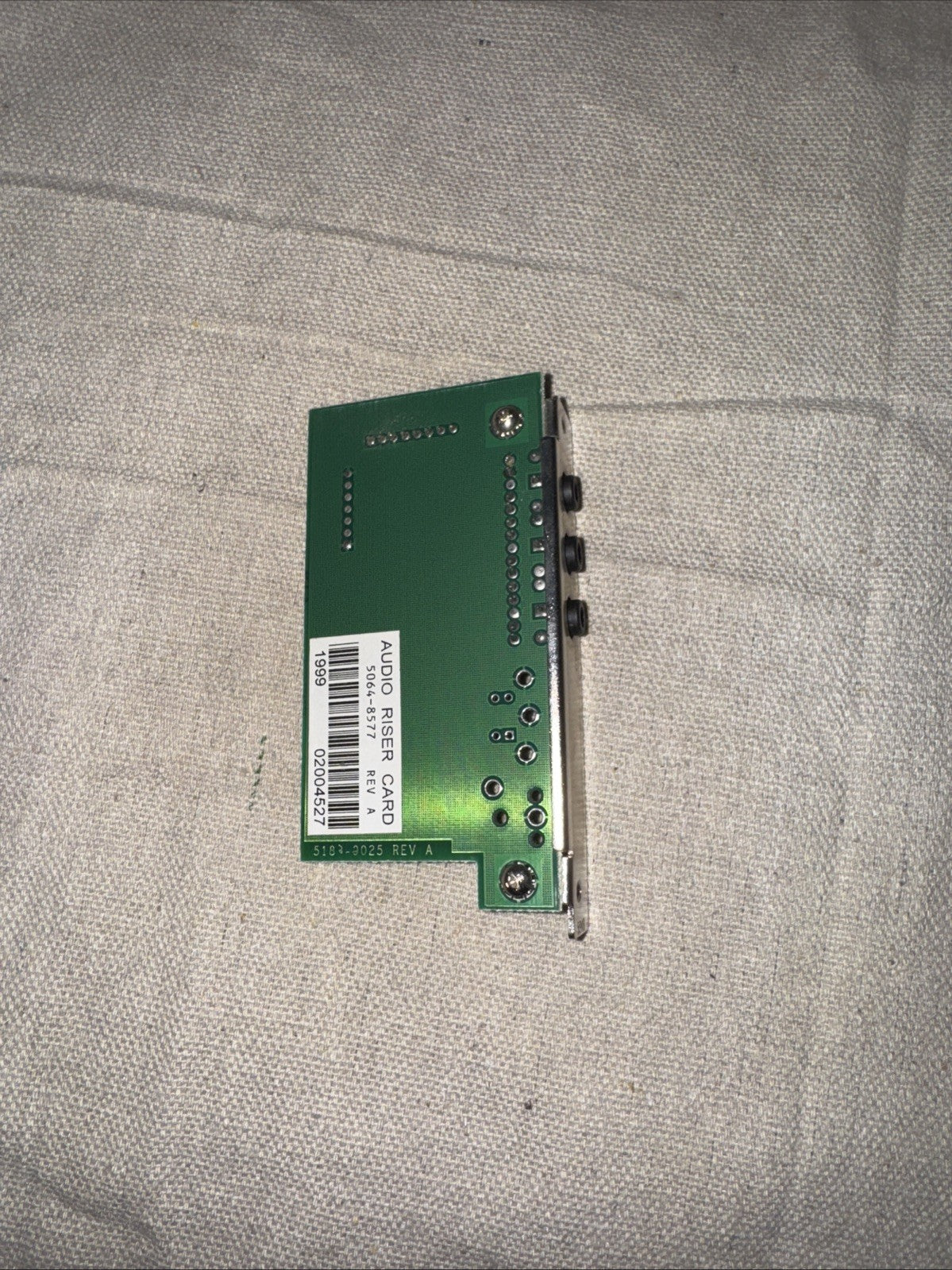HP Audio Riser Card P/N 5064-8577, Rev A displayed on a fabric surface, used condition.