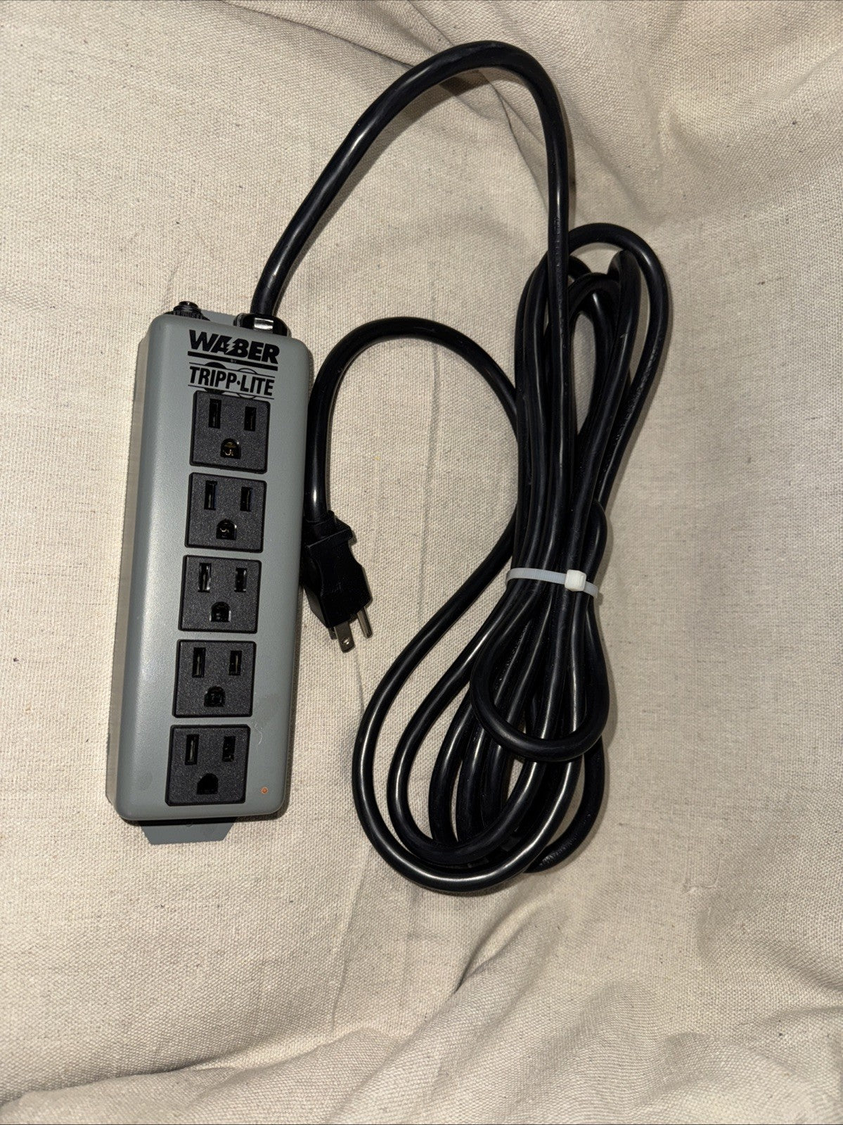 Eaton Corp 602-15 Tripp Lite Waber Power Strip 5-Outlet Industrial 5-15R 5-15P with power cord on fabric background