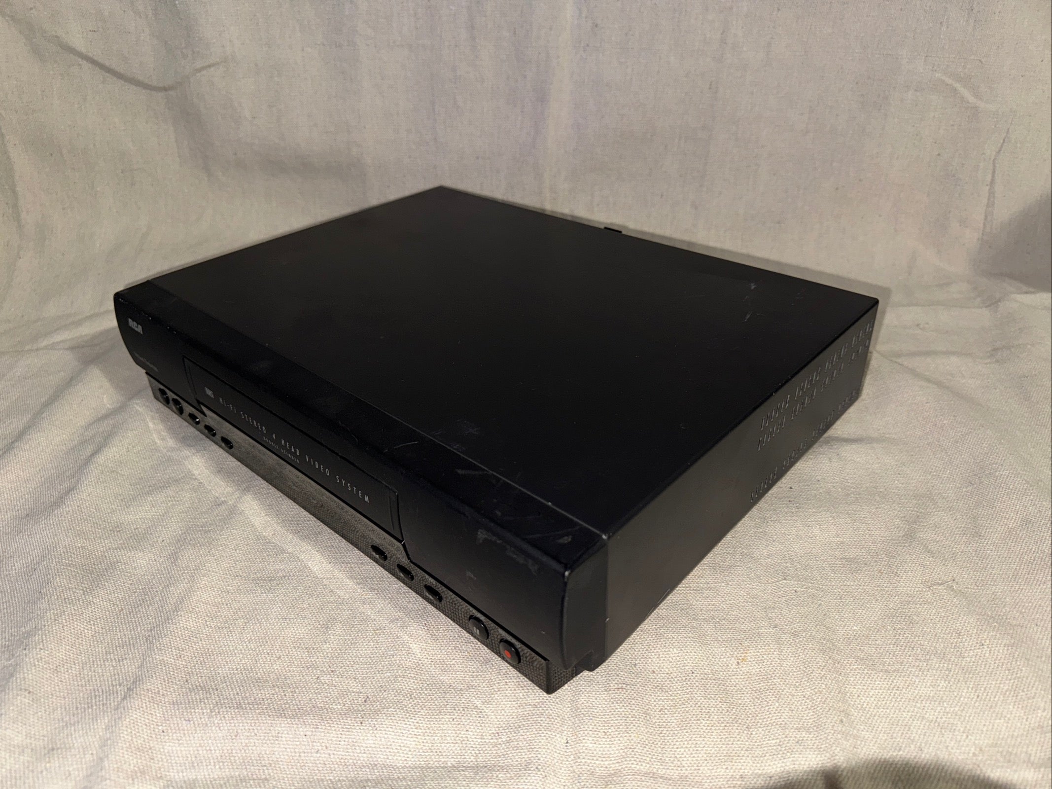 Serviced RCA VR606HF VCR VHS Recorder Player on a neutral background, showcasing its sleek design.