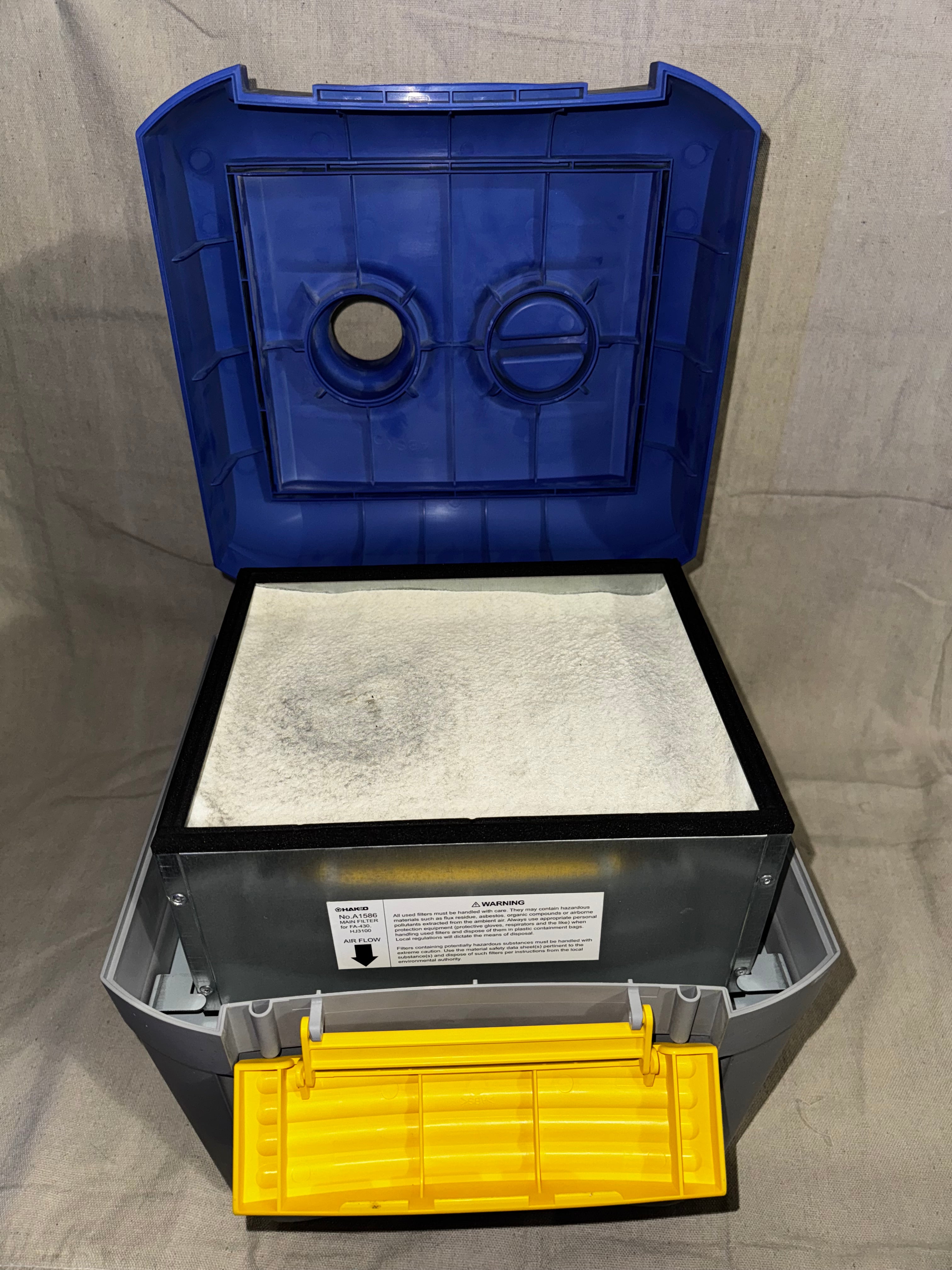 Hakko FA-430 Soldering Fume Extractor with open lid showing filter and yellow drawer.