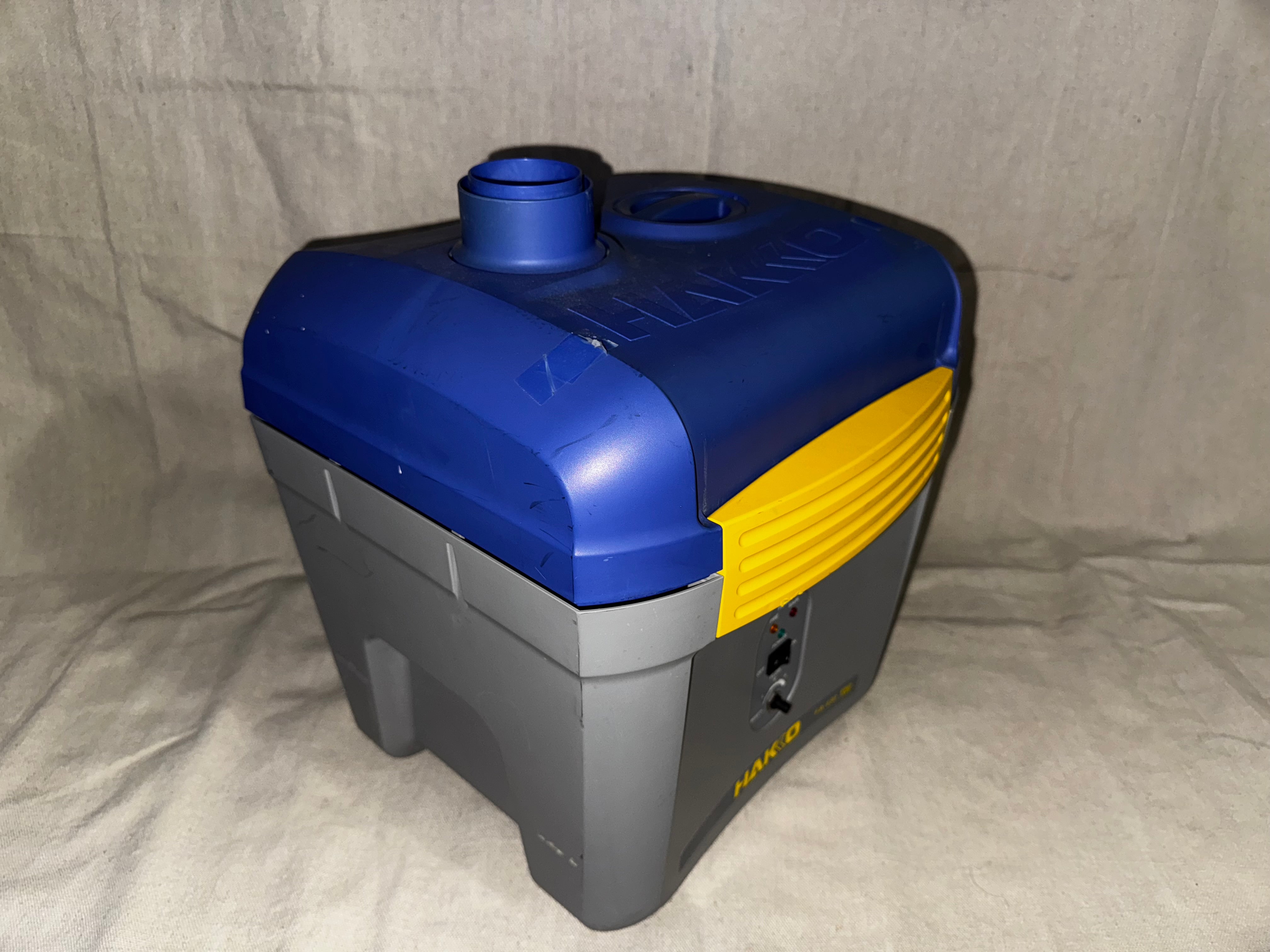 Hakko FA-430 Soldering Fume Extractor side view showcasing its compact design and ventilation features.