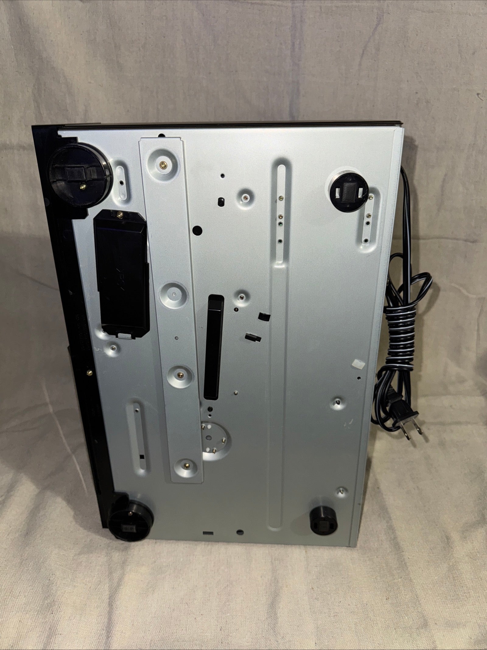 Serviced Sony CDP-CX50 on a beige background showing its sleek silver design and connection ports.
