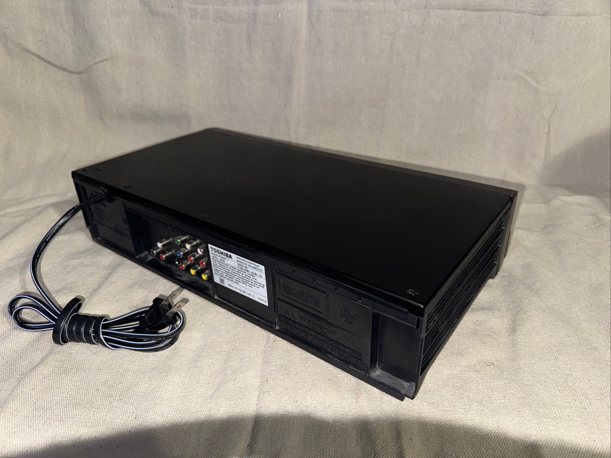 Serviced Toshiba SD-V296 DVD VHS Recorder With Remote, back view showing connections and power cable.