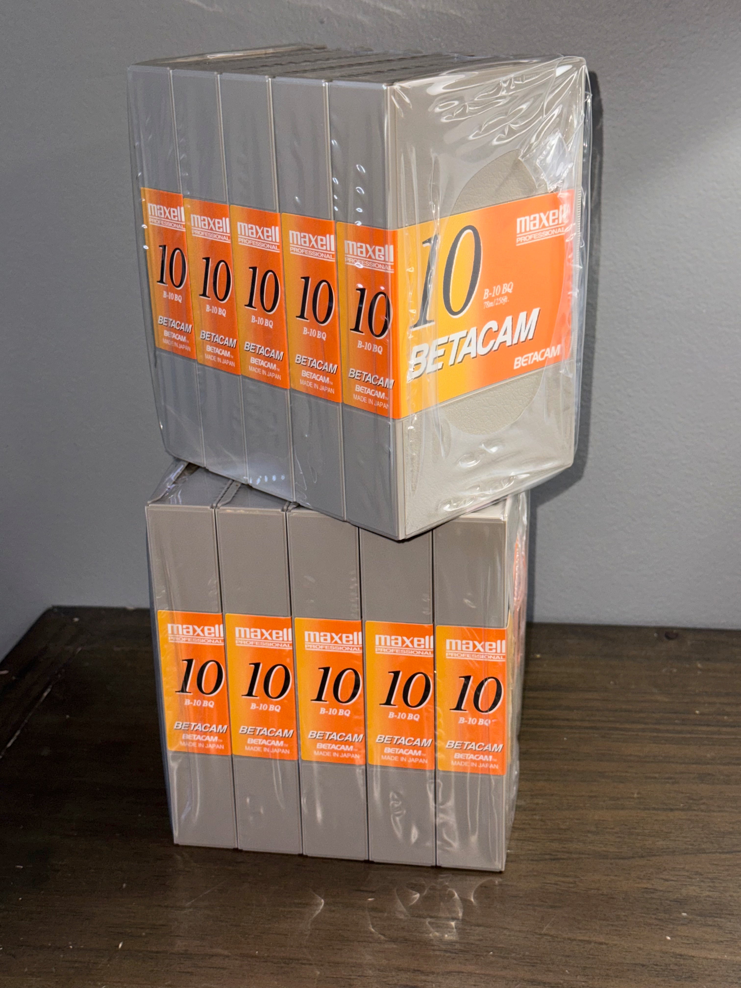 Maxell Professional B-10 BQ Blank Betacam Tape Lot Of 10 Tapes in sealed packaging on a wooden surface.