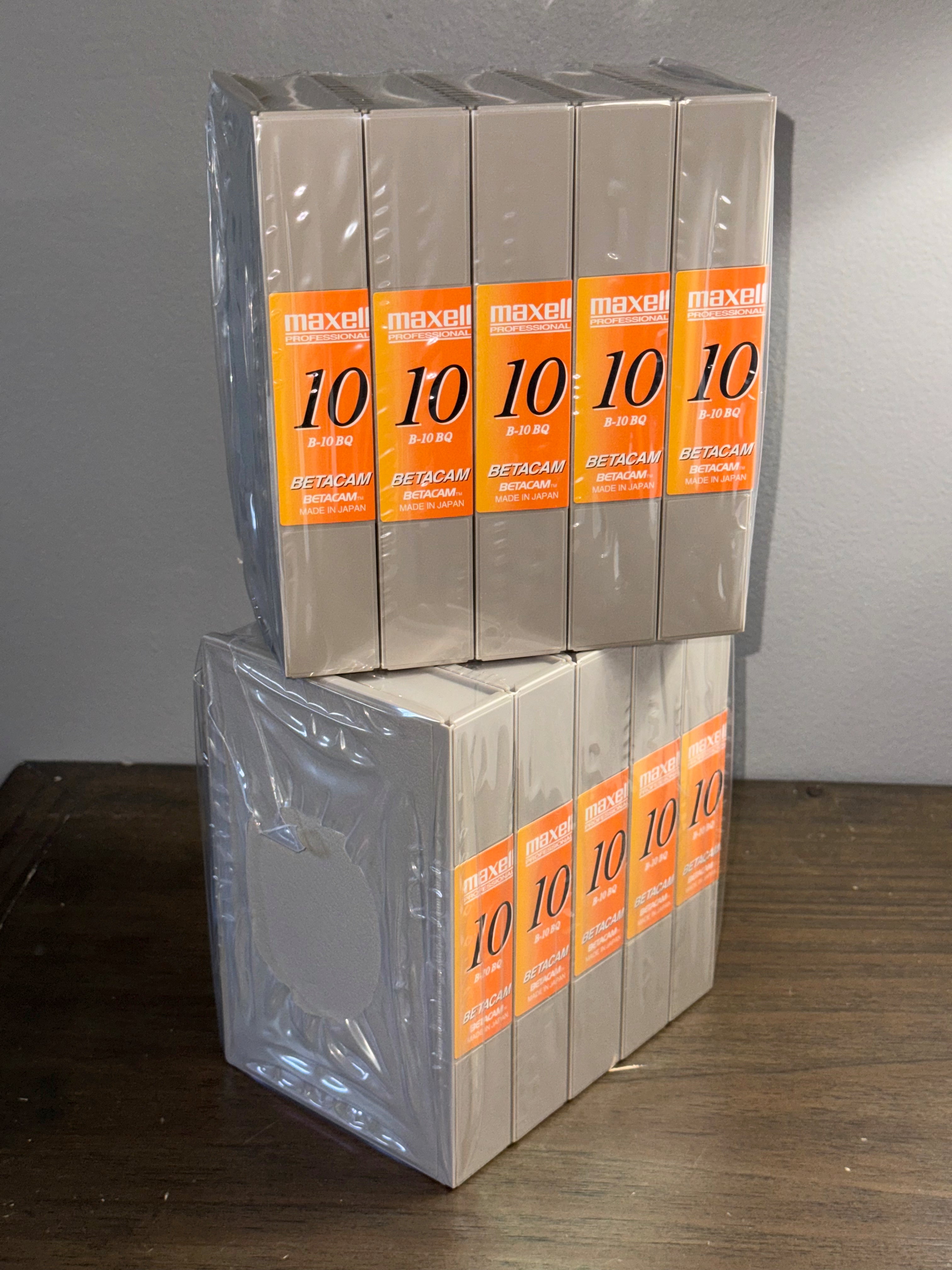Maxell Professional B-10 BQ Blank Betacam Tape Lot Of 10 Tapes stacked in packaging on a wooden surface.